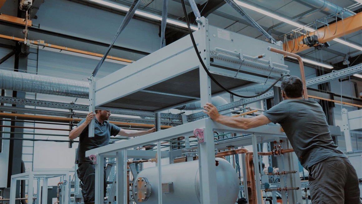 Two employees constructing a plant.