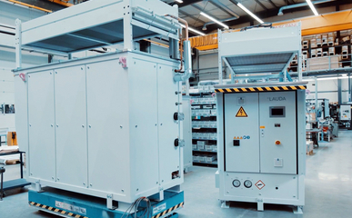 Two SUK units in a production hall, one is at right angles to the viewer on the left of the picture, the other shows its front and is on the right of the picture.