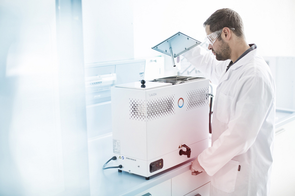 A laboratory technician works with a still in the laboratory.